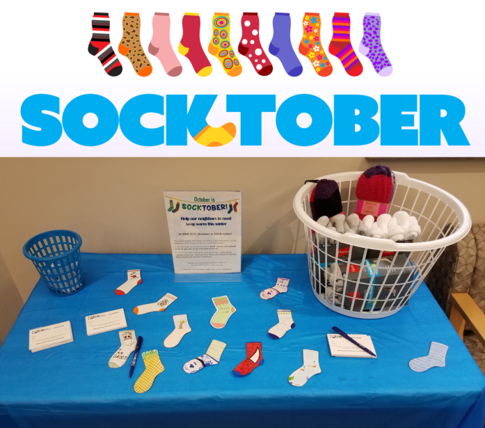 Socktober image with socks on donation table.