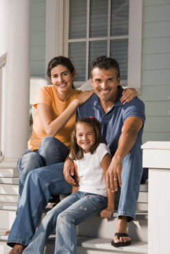 Young Family Sitting On Porch Image