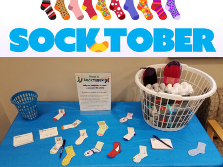 Socktober image with socks on donation table.